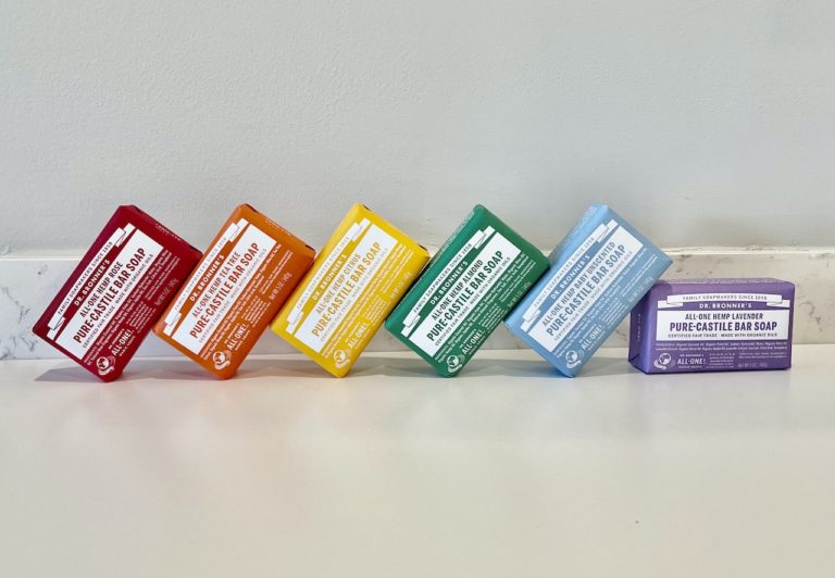 Dr. Bronner's bar soap, red, orange, yellow, green, blue, purple lined up on countertop