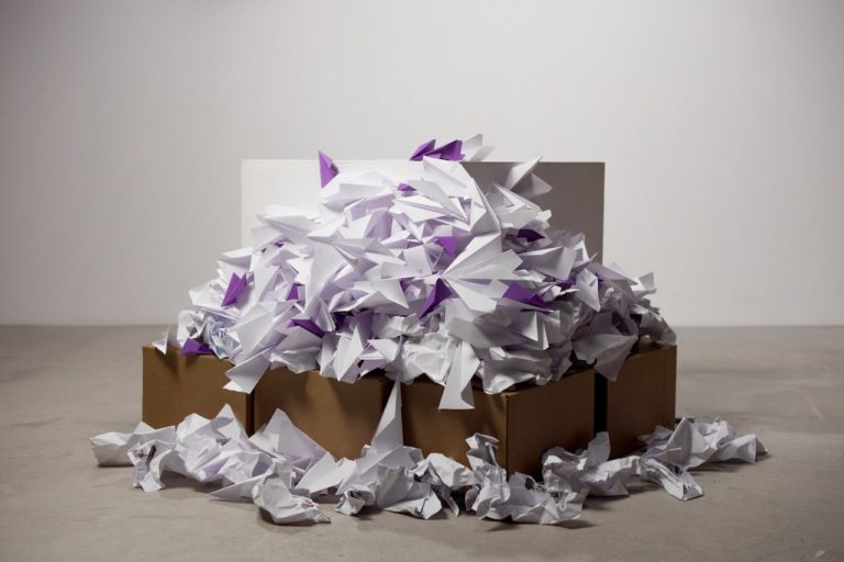 paper packaging overflowing out of cardboard box