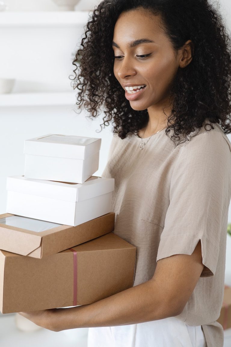 woman holding regular cardboard boxes