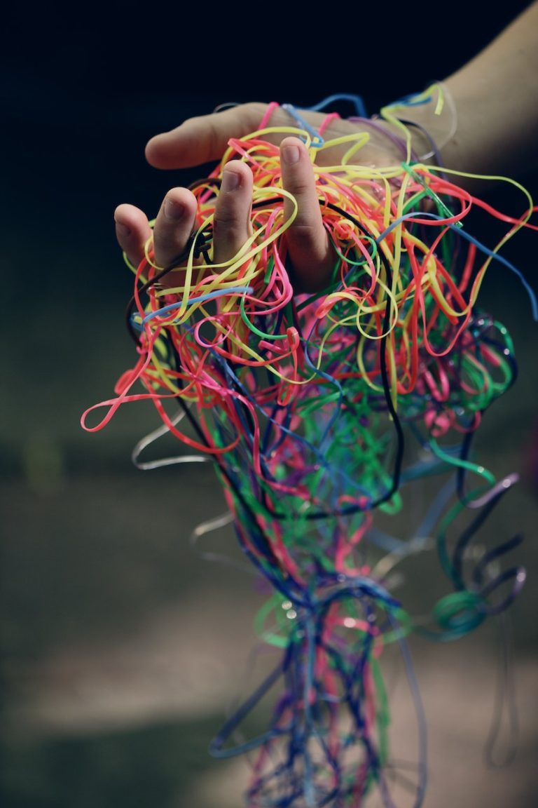 tangled string in person's hand
