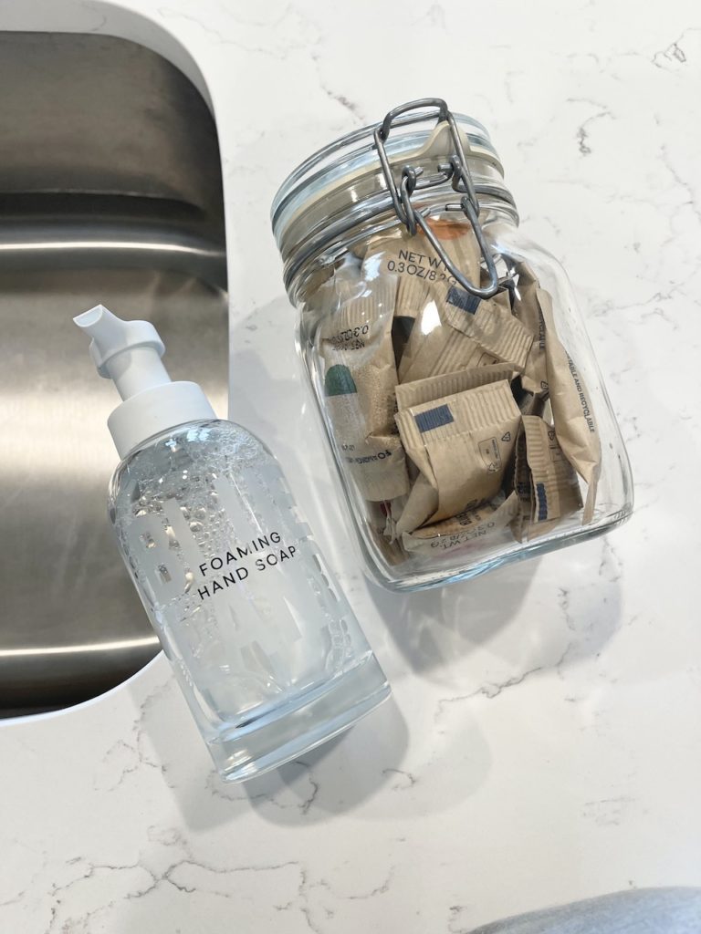 blueland hand soap forever bottle with soap refills in glass jar on marble countertop