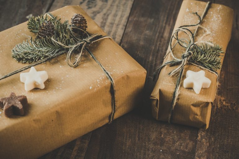 gifts wrapped with brown paper and twine, garnished with dried tree clippings
