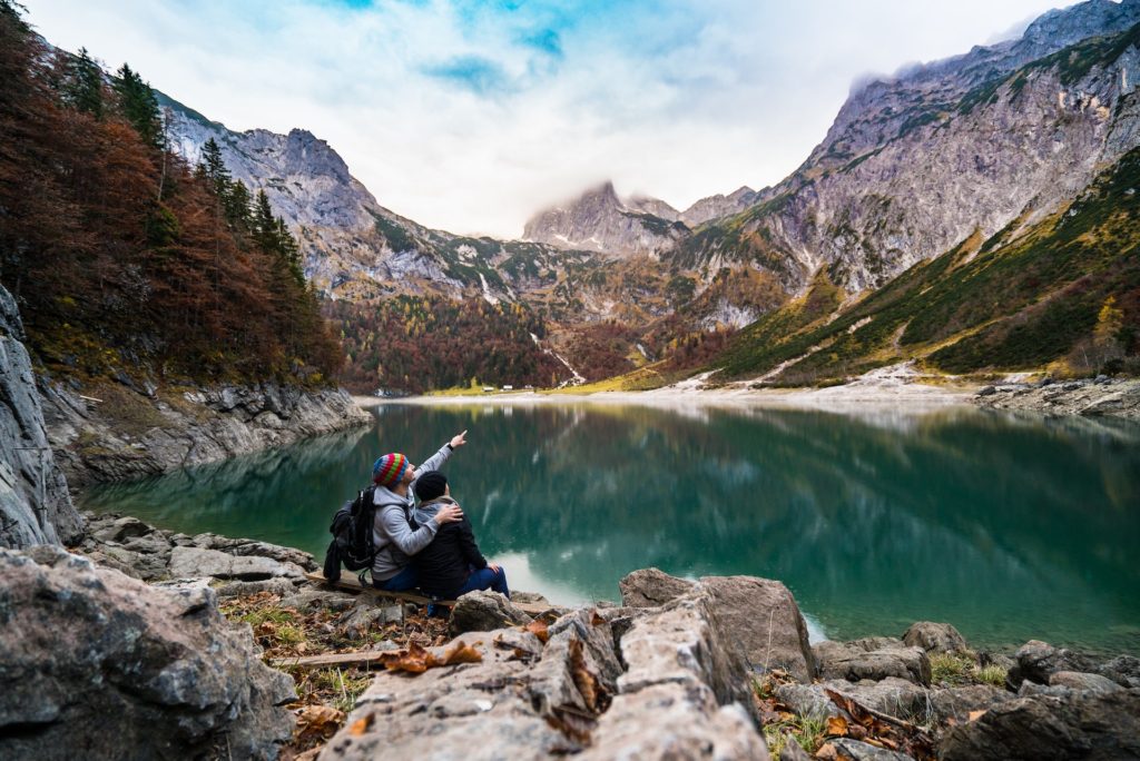 couple enjoying mountain scenery from hiking date