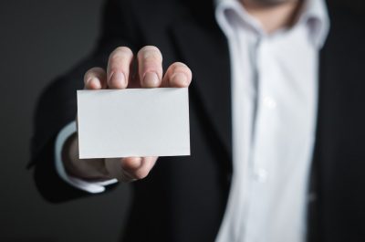 business man holding up business card